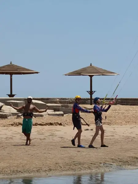 Instructor and students on the beach