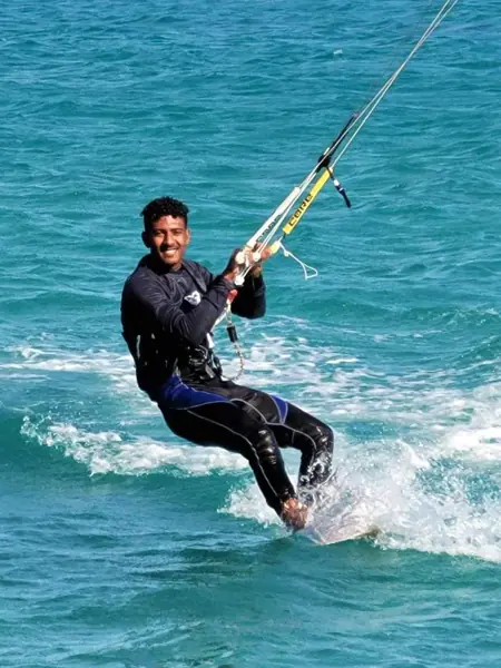 Instructor kiteboarding with a big smile