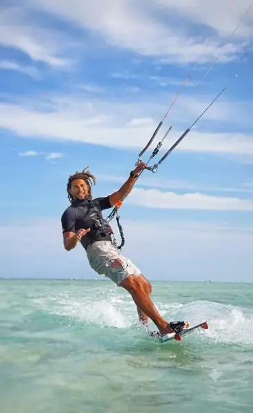 Kiteboarder riding on turquoise water