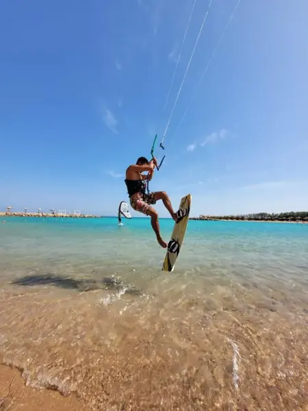 Instructor jumping with a kiteboard
