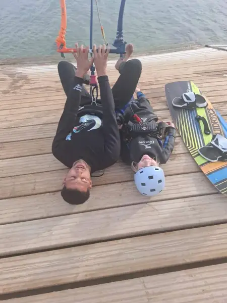 Instructor and child with the kite bar on the deck