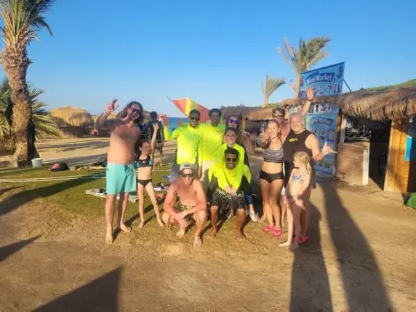 Families and the Kite Fly team on the beach