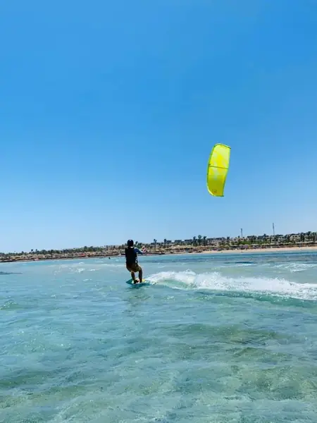 Kiteboarder with a yellow kite